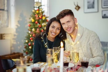 happy couple celebrating christmas decorated with a chain of lights