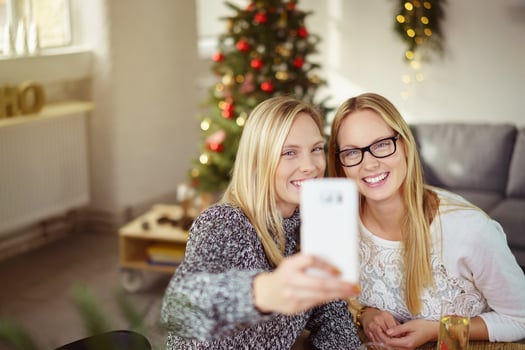 sisters taking a selfie while having christmas dinner at home